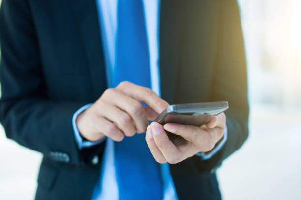 istock Close up of businessman using mobile phone 657367990