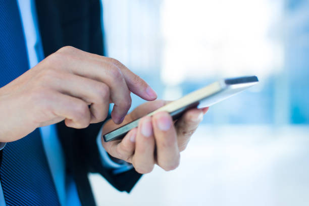 istock Close up of businessman using mobile phone 657368030