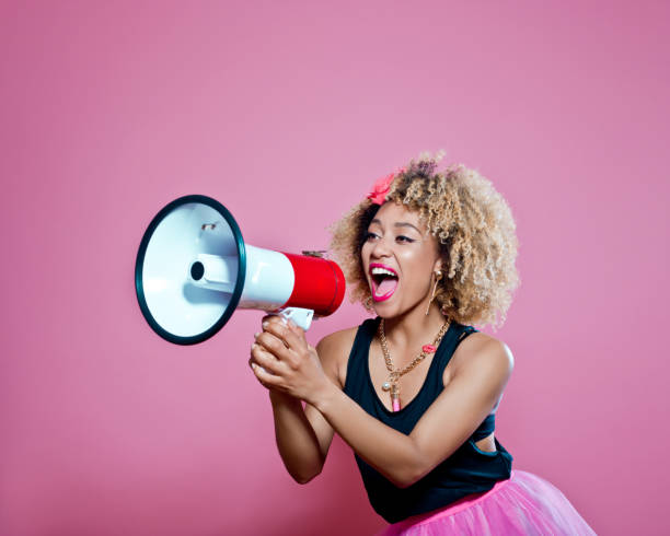 istock Afro woman holding screaming into megaphone 657369170