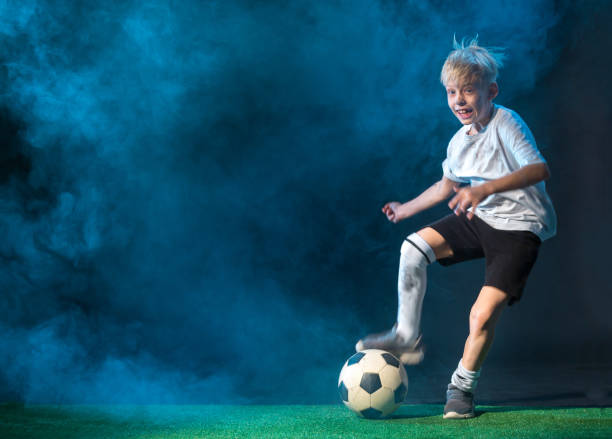 istock Happy Boy Playing Street Football 657372518