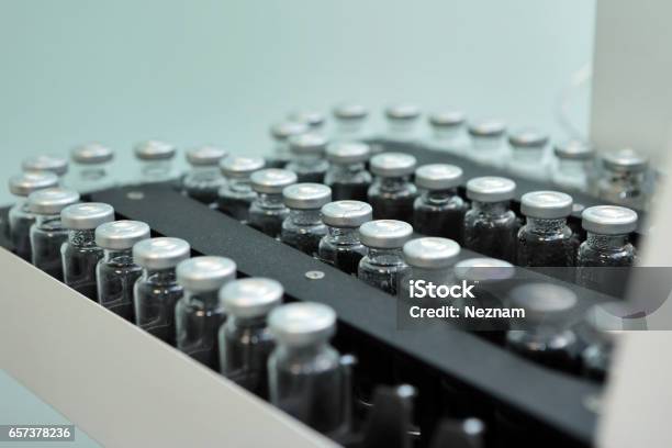 Sterile Capsules For Injection Bottles On The Bottling Line Of The Pharmaceutical Plant Machine After Checking Sterile Liquids Interferon Nasoferon Stock Photo - Download Image Now