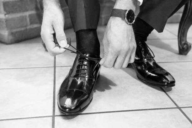 istock The elegant man laces shoes 657378318