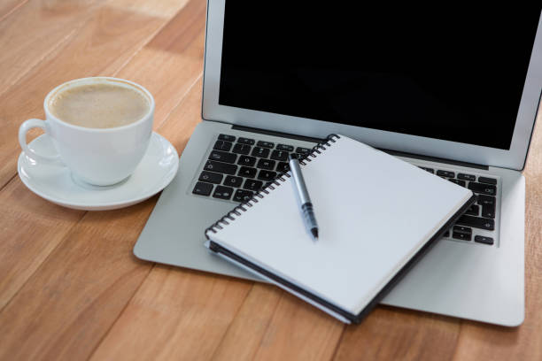 istock Cup of coffee with organizer and laptop 657382016
