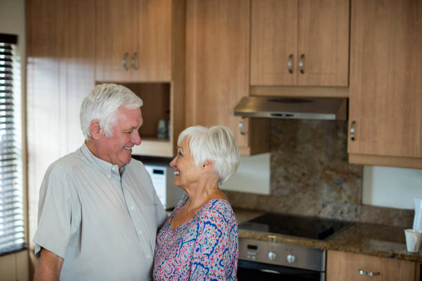 istock Happy senior couple looking at each other in kitchen 657382404