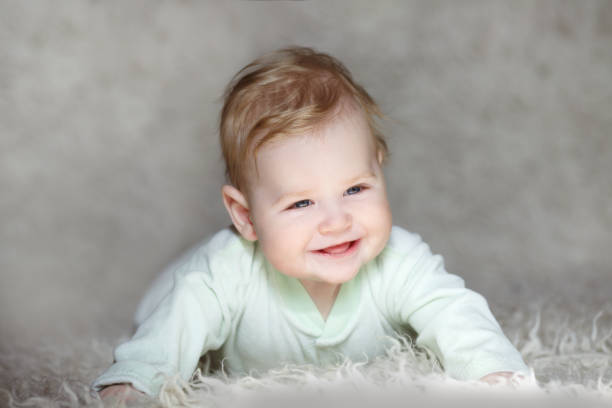 istock Happy smiling baby on a gray background 657382716