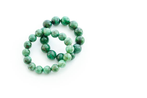 istock Beautiful valuable Emerald stone beads in bracelet on white background 657384828