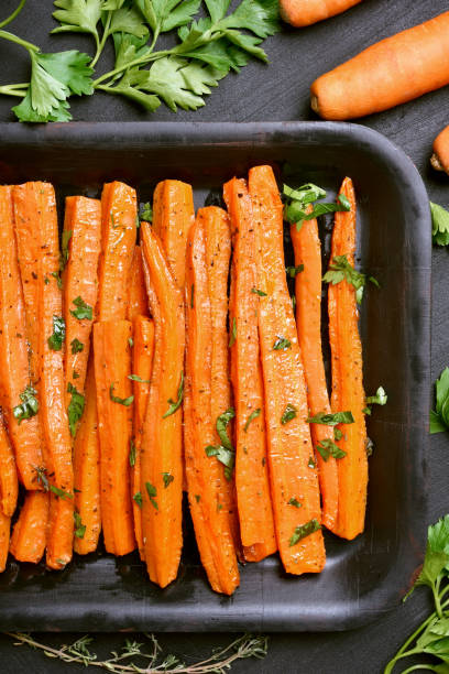 istock Roasted carrots with green herbs 657385040