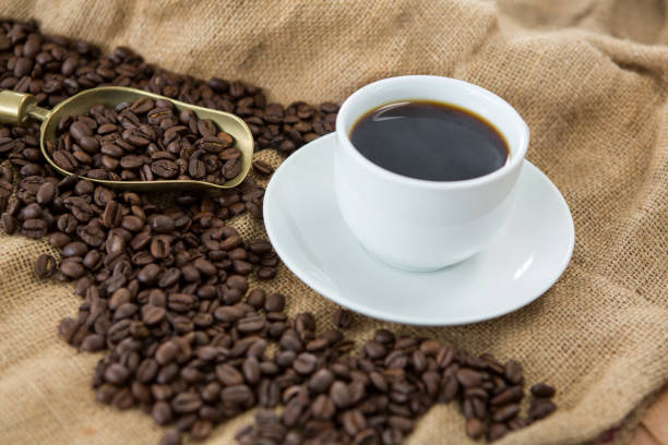 istock Black coffee, roasted beans and scoop on sack 657385044
