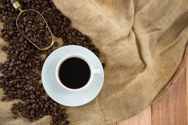 istock Black coffee, roasted beans and scoop on sack 657385070