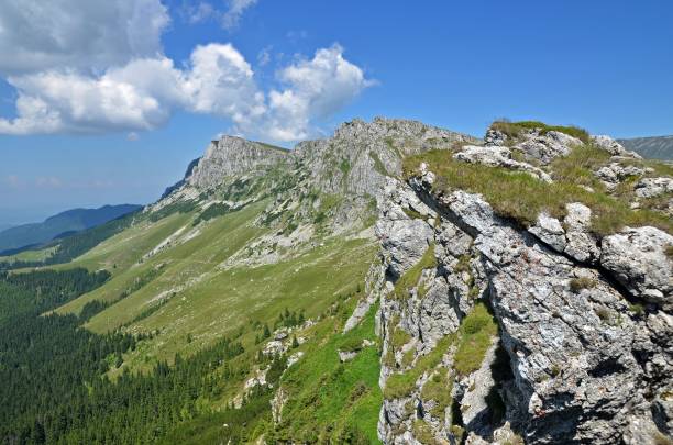 istock Tourist path in mountains with high cliffs in summer time 657385928