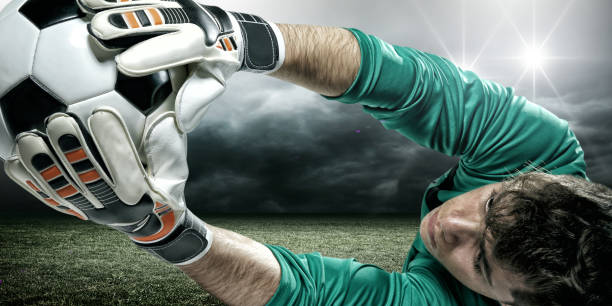 Goalkeeper ready to save on white studio background. Soccer football concept