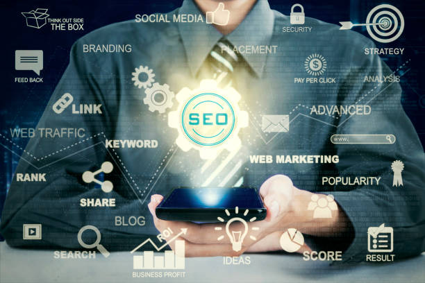 istock Hand holds cellphone with SEO icon 657391912