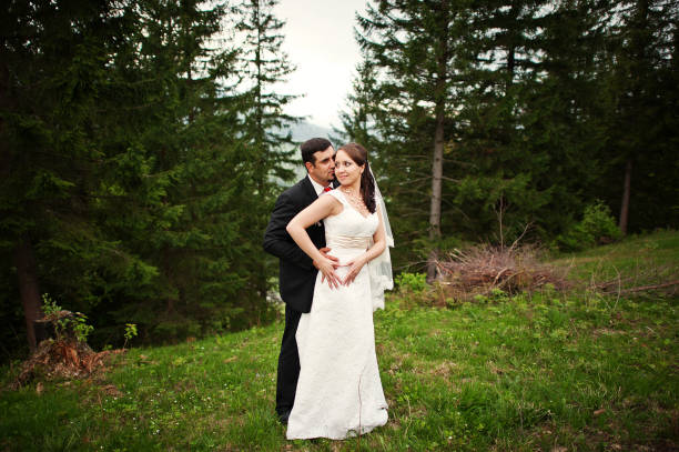 istock wedding couple  holding hands in a forest 657392056