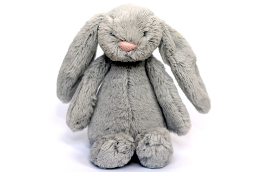 A soft fluffy grey rabbit toy for a baby or child