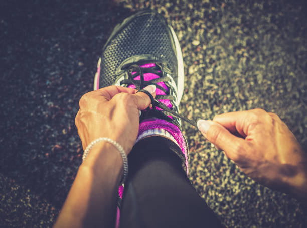 istock Woman tying shoes for running 657396142