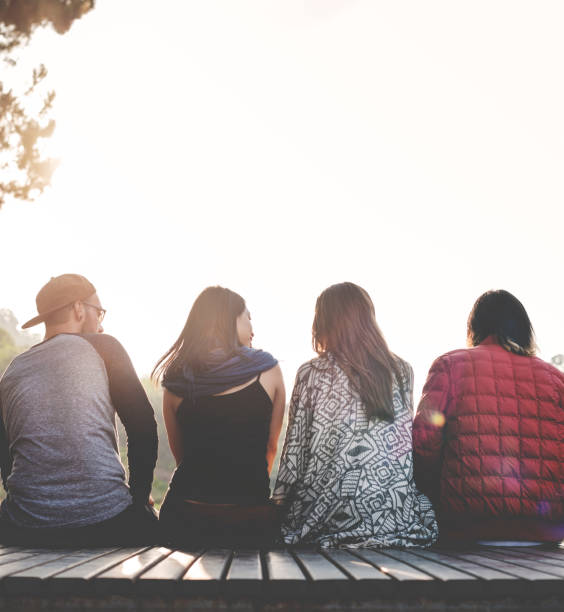 istock Friends Sitting in a Row Outdoors Concept 657396212