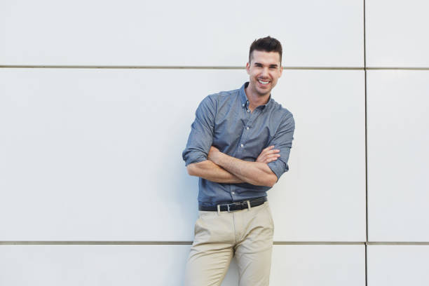 istock attractive young business man standing with arms crossed 657396246