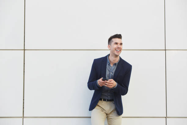 istock laughing business man sending text message on phone 657396248