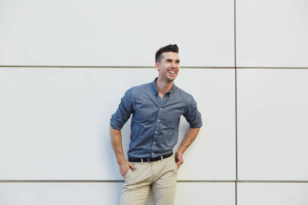 istock laughing friendly business man standing by white wall 657396282