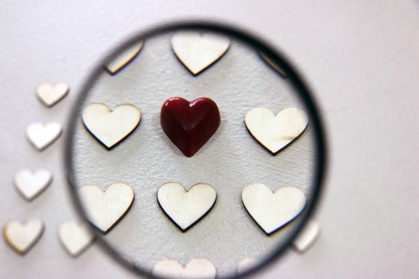 istock Looking for different heart between the bunch of wooden same hearts 657396316