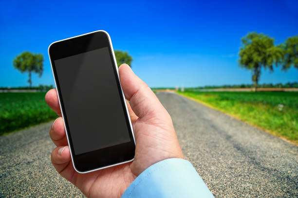istock Smartphone in hand with a blank area to insert a custom image. Beautiful landscape on background 657396392