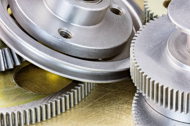 istock pulleys and cogwheels on scratched brass background 657399244