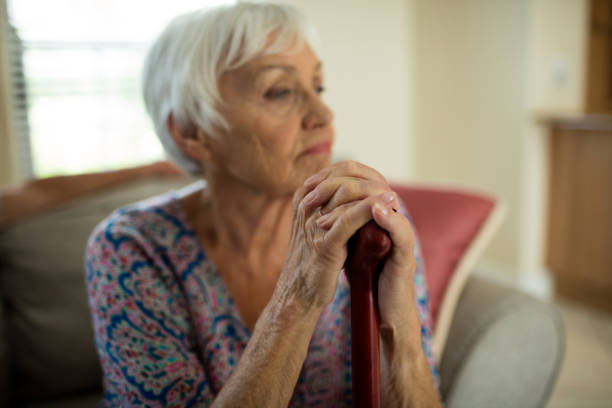 istock Sad senior woman sitting on couch 657399548