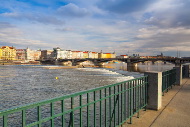 Prague,Czech Republic - March 20,2017: View on the Prague panorama with Jirasek bridge at sunset.The Prague bridges arching over the Vltava River are not only vital connecting links, but also valuable works of architecture .
