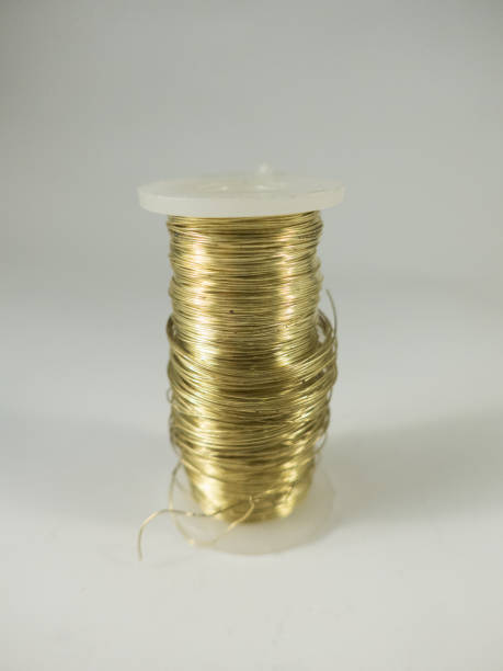 istock spool of golden metal thread 657404448