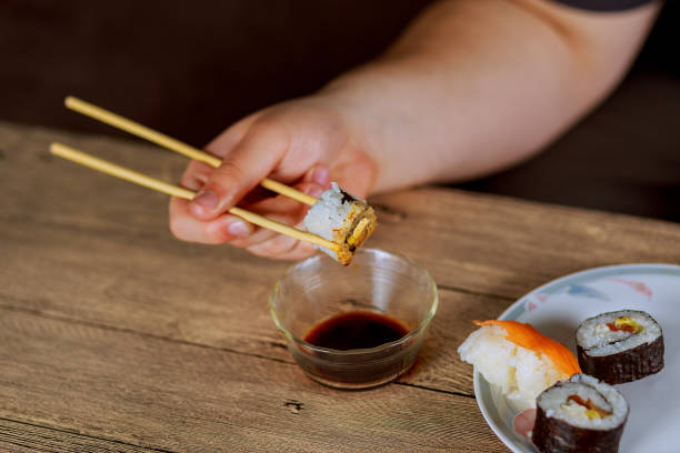 istock Set sushi set. Hand with chopsticks for sushi. 657407324