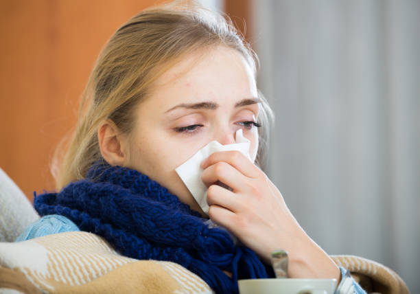 istock Adult female under blanket with flu attack indoors 657407328