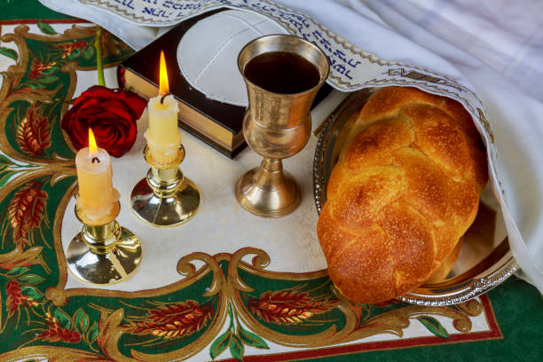istock Shabbat eve table with challah bread, candles and kippah. 657407598