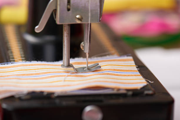 retro sewing machine closeup, needle and textile, the tailor profession concept