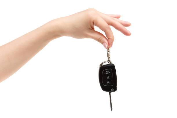 istock Female hand holds car keys on white background. 657408324
