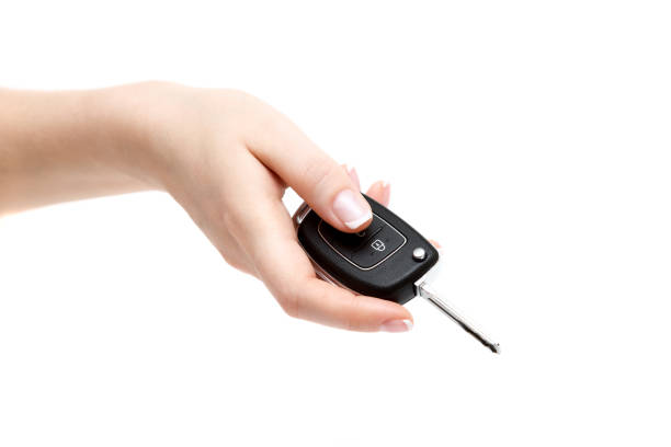 istock Female hand holds car keys on white background. 657408374