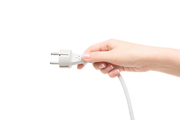 istock Female hand holds electric cable on a white background. 657410386