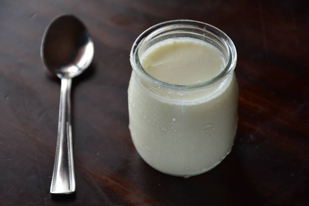 istock yogurt in a jar with a silver spoon on a wooden table 657412606