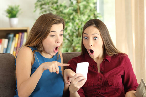 istock Amazed roommates online with phone 657414238