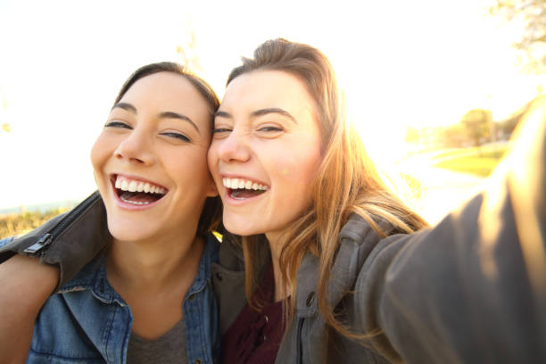 istock Funny friends taking selfies at sunset 657415448