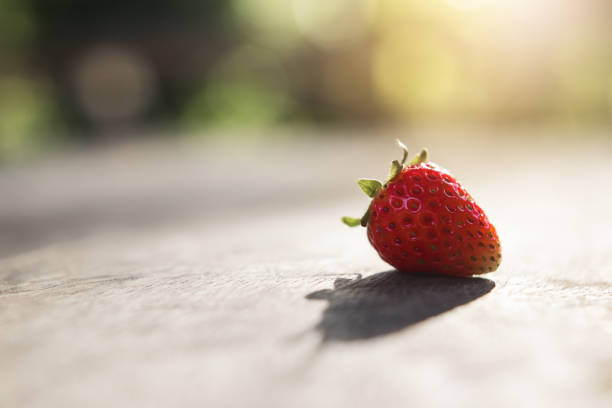 Fresh strawberry on the wood in the morning