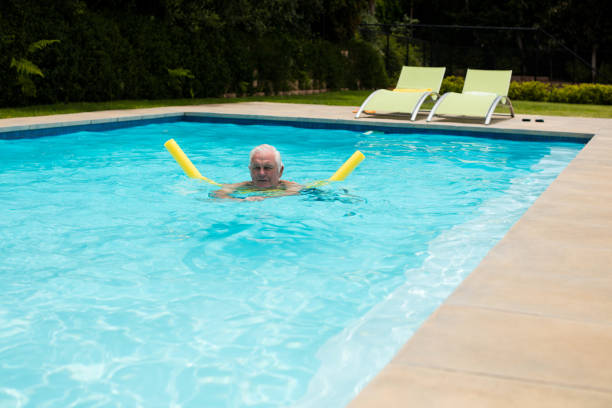 istock Senior man swimming with inflatable tube 657422118