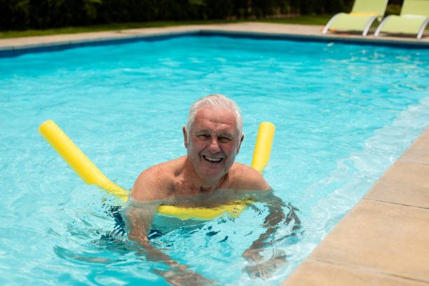 istock Senior man swimming with inflatable tube 657422190