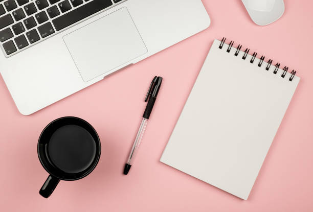 istock Modern office desk table with laptop, blank notebook page for input the text in the middle and other supplies. Top view, flat lay 657424746