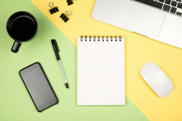 istock Modern office desk table with laptop, blank notebook page for input the text in the middle and other supplies. Top view, flat lay 657424768