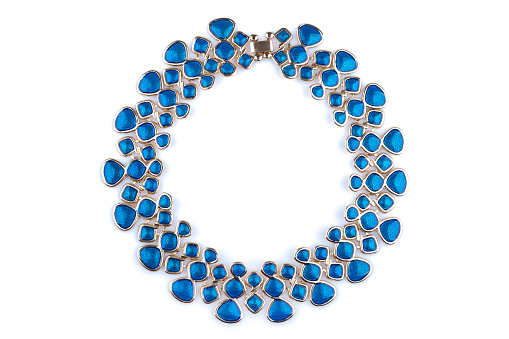 Gold necklace with blue rhinestones, isolated on white.