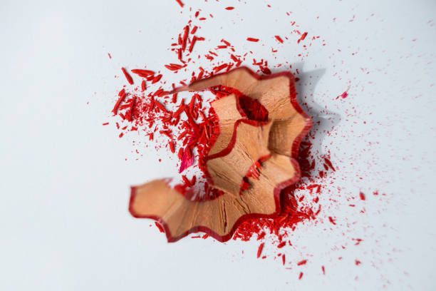 istock Red color pencils shavings on a white background 657429900
