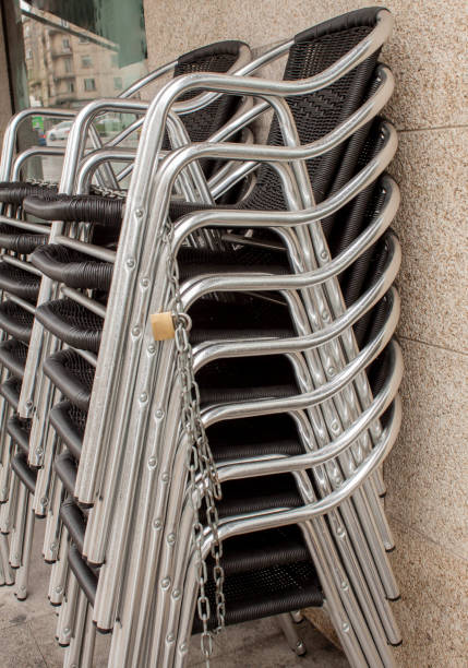 istock Bar chairs stacked on a terrace in a street in spain 657435706