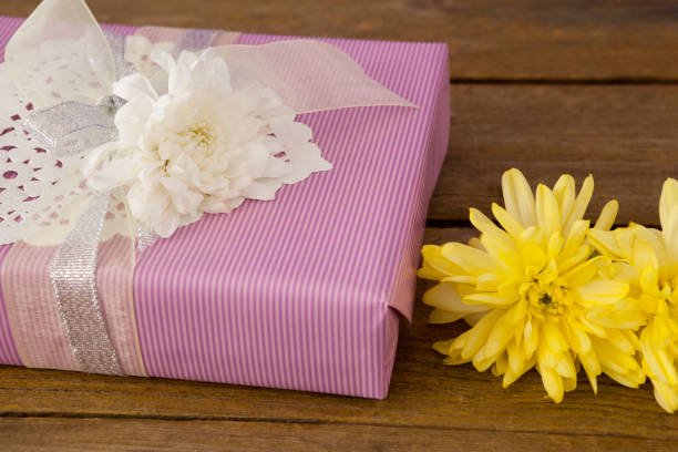 istock Gift box with flowers on wooden table 657435806