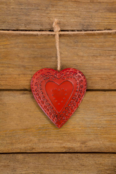 istock Red textured heart hanging on rope 657436404