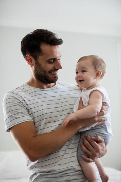 istock Father holding his baby girl 657439372